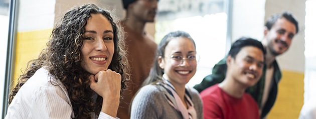 Horizontal banner or header with university students multiethnic team studying together on a new project in creative coworking classroom - Bright filter with focus on first woman on left